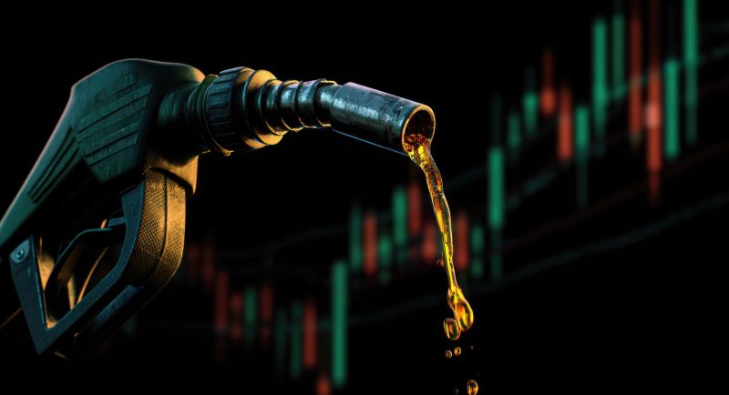 energy shortage crisis picture of gasoline petroleum fuel nozzle with blurred background of oil price graph of the energy business market.